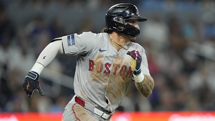 Sep 23, 2024; Toronto, Ontario, CAN; Boston Red Sox left fielder Jarren Duran (16) runs to first on his triple against the Toronto Blue Jays during the sixth inning at Rogers Centre. Mandatory Credit: John E. Sokolowski-Imagn Images