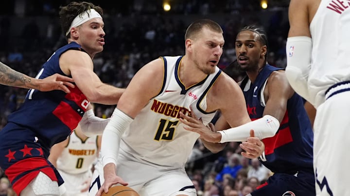 Mar 15, 2025; Denver, Colorado, USA; Washington Wizards forward Alex Sarr (20) defends Denver Nuggets center Nikola Jokic (15) in the second quarter at Ball Arena. Mandatory Credit: Ron Chenoy-Imagn Images