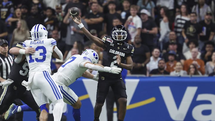 Dec 28, 2024; San Antonio, TX, USA; Colorado Buffaloes quarterback Shedeur Sanders (2) attempts a pass as Brigham Young Cougars linebacker Jack Kelly (17) defends during the second quarter at Alamodome. Mandatory Credit: Troy Taormina-Imagn Images