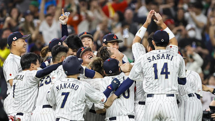 Mar 20, 2023; Miami, Florida, USA; Team Japan celebrates on the field after winning the game with a walk-off double from Japan third base Munetaka Murakami (center) during the ninth inning against Mexico at LoanDepot Park. Mandatory Credit: Sam Navarro-Imagn Images