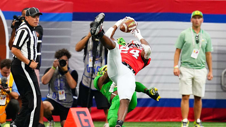 Sep 3, 2022; Atlanta, Georgia, USA; Georgia Bulldogs defensive back Malaki Starks (24) pulls down an interception against Oregon Ducks wide receiver Seven McGee (7) during the first quarter of the Chick-fil-A kickoff game at Mercedes-Benz Stadium. Mandatory Credit: John David Mercer-Imagn Images
