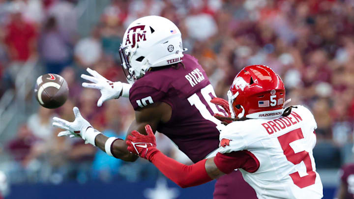 Sep 28, 2024; Arlington, Texas, USA;  Texas A&M Aggies defensive back Dezz Ricks (10) intercepts a pass intended for Arkansas Razorbacks wide receiver Tyrone Broden (5) during the first half at AT&T Stadium. Mandatory Credit: Kevin Jairaj-Imagn Images