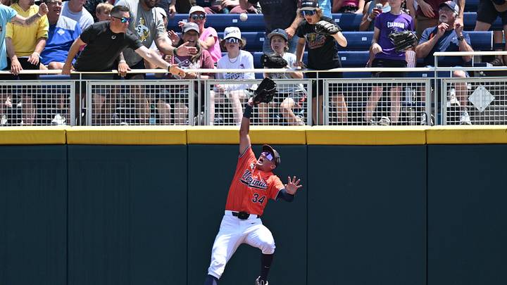 Jun 16, 2024; Omaha, NE, USA; Virginia Cavaliers center fielder Harrison Didawick (34) makes a catch against the wall against the Florida State Seminoles during the second inning at Charles Schwab Field Omaha. Mandatory Credit: Steven Branscombe-Imagn Images Jun 16, 2024; Omaha, NE, USA; Virginia Cavaliers center fielder Harrison Didawick (34) makes a catch against the wall against the Florida State Seminoles during the second inning at Charles Schwab Field Omaha. Mandatory Credit: Steven Branscombe-Imagn Images