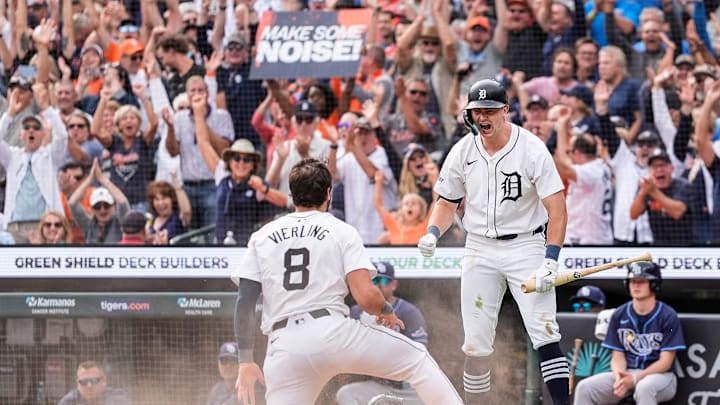 Detroit Tigers left fielder Matt Vierling (8) slides into the home base to score a run against Tampa Bay Rays as shortstop Trey Sweeney (27) celebrates during the eighth inning at Comerica Park in Detroit on Thursday, Sept. 26, 2024. Detroit Tigers left fielder Matt Vierling (8) slides into the home base to score a run against Tampa Bay Rays as shortstop Trey Sweeney (27) celebrates during the eighth inning at Comerica Park in Detroit on Thursday, Sept. 26, 2024.