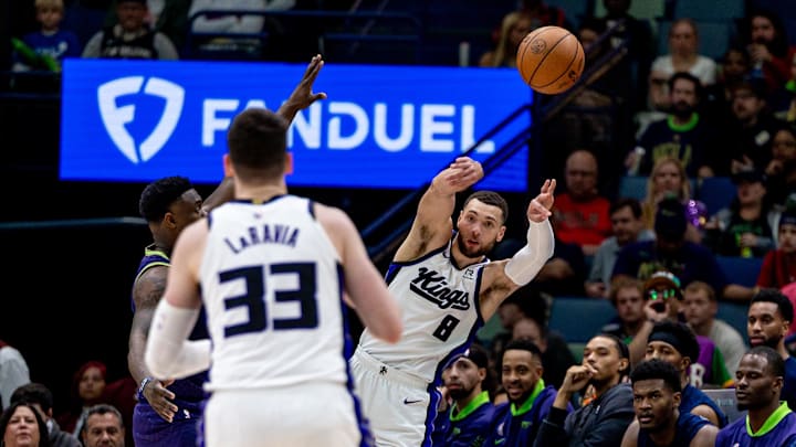 Feb 12, 2025; New Orleans, Louisiana, USA;  Sacramento Kings guard Zach LaVine (8) passes the ball to forward Jake LaRavia (33) against New Orleans Pelicans forward Zion Williamson (1) during the second half at Smoothie King Center. Mandatory Credit: Stephen Lew-Imagn Images