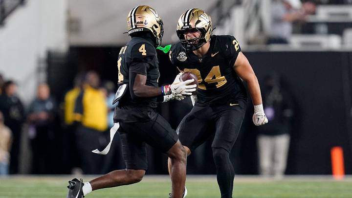 Vanderbilt cornerback Martel Hight (4) celebrates intercepting a Kentucky ball with linebacker Nick Rinaldi (24) during the fourth quarter at FirstBank Stadium in Nashville, Tenn., Saturday, Nov. 22, 2025.