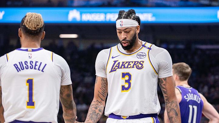 Dec 21, 2024; Sacramento, California, USA; Los Angeles Lakers guard D'Angelo Russell (1) high fives forward Anthony Davis (3) after scoring against the Sacramento Kings during the second quarter at Golden 1 Center. Mandatory Credit: Ed Szczepanski-Imagn Images