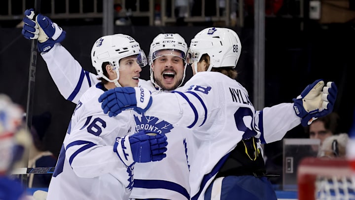 Dec 12, 2023; New York, New York, USA; Toronto Maple Leafs right wing Mitchell Marner (16) celebrates his goal against the New York Rangers with center Auston Matthews (34) and right wing William Nylander (88) during the first period at Madison Square Garden. Mandatory Credit: Brad Penner-Imagn Images