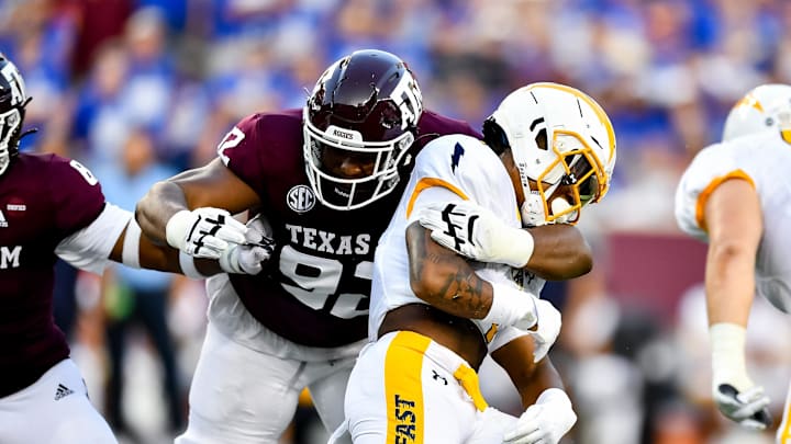 Sep 4, 2021;  College Station, Texas, USA;  Texas A&M Aggies defensive lineman Jayden Peevy (92) tackles Kent State Golden Flashes running back Marquez Cooper (1) during the first half at Kyle Field. Mandatory Credit: Maria Lysaker-Imagn Images