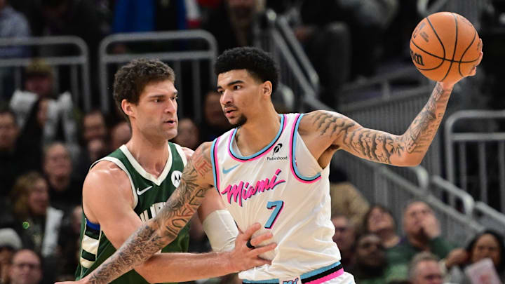 Jan 23, 2025; Milwaukee, Wisconsin, USA; Miami Heat center Kel'el Ware (7) is guarded by Milwaukee Bucks center Brook Lopez (11)in the third quarter at Fiserv Forum. Mandatory Credit: Benny Sieu-Imagn Images