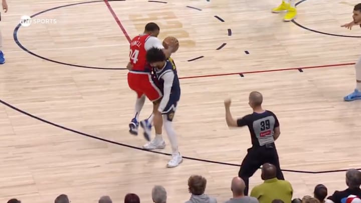 Los Angeles Clippers' Norman Powell is picked up by Denver Nuggets' Jamal Murray on April 22, 2025.