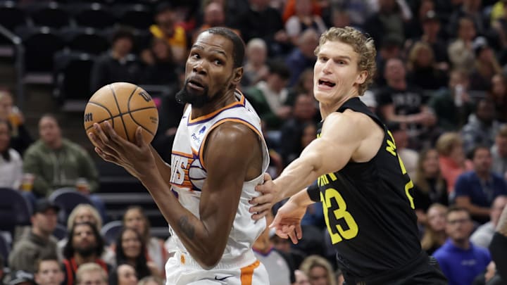 Nov 19, 2023; Salt Lake City, Utah, USA;  Phoenix Suns forward Kevin Durant (35) tries to get past Utah Jazz forward Lauri Markkanen (23) during the first quarter at Delta Center. Mandatory Credit: Chris Nicoll-Imagn Images