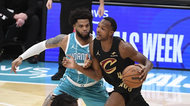 Jan 21, 2026; Charlotte, North Carolina, USA;  Cleveland Cavaliers forward center Evan Mobley (4) drives past Charlotte Hornets forward Miles Bridges (0) during the first half at the Spectrum Center. Mandatory Credit: Sam Sharpe-Imagn Images