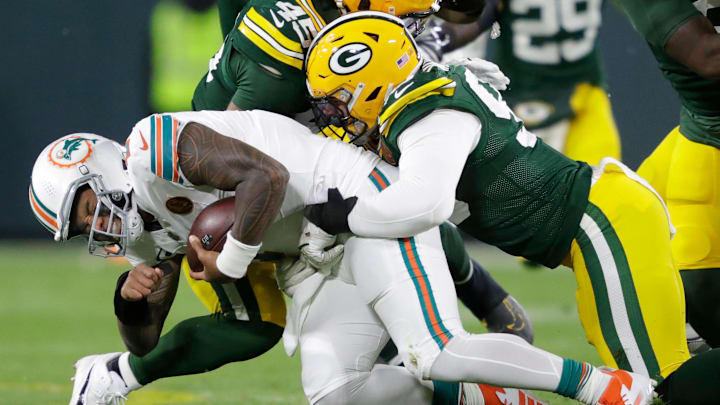 Miami Dolphins quarterback Tua Tagovailoa (1) is sacked by Green Bay Packers defensive end Lukas Van Ness (90) during their football game Thursday, November 28, 2024, at Lambeau Field in Green Bay, Wisconsin.