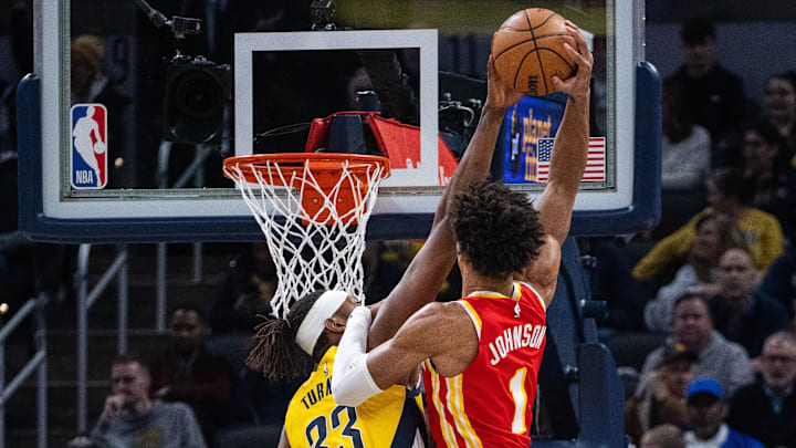 Jan 5, 2024; Indianapolis, Indiana, USA; Indiana Pacers center Myles Turner (33) blocks Atlanta Hawks forward Jalen Johnson (1) in the first half at Gainbridge Fieldhouse. Mandatory Credit: Trevor Ruszkowski-Imagn Images