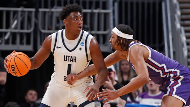 Utah State Aggies forward Great Osobor (1) is guarded by TCU Horned Frogs forward Xavier Cork (12)