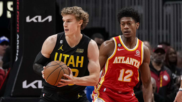 Nov 9, 2022; Atlanta, Georgia, USA; Utah Jazz forward Lauri Markkanen (23) handles the ball in front off Atlanta Hawks forward De'Andre Hunter (12) during the first half at State Farm Arena. Mandatory Credit: Dale Zanine-USA TODAY Sports