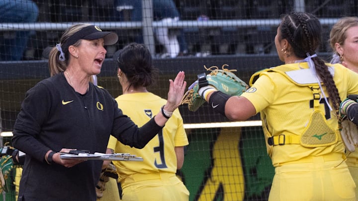 Oregon softball head coach Coach Melyssa Lombardi high-fives her team during the Jane Sanders Classic softball tournament in Eugene, Saturday, March 8, 2025.