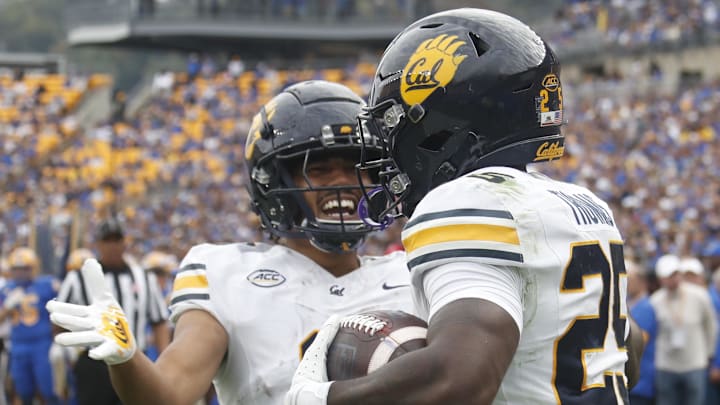 Oct 12, 2024; Pittsburgh, Pennsylvania, USA; California Golden Bears wide receiver Mikey Matthews (left) congratulates running back Jaivian Thomas (25) on his touchdown against the Pittsburgh Panthers during the first quarter at Acrisure Stadium. Mandatory Credit: Charles LeClaire-Imagn Images Oct 12, 2024; Pittsburgh, Pennsylvania, USA; California Golden Bears wide receiver Mikey Matthews (left) congratulates running back Jaivian Thomas (25) on his touchdown against the Pittsburgh Panthers during the first quarter at Acrisure Stadium. Mandatory Credit: Charles LeClaire-Imagn Images