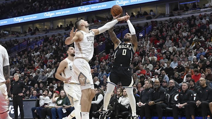 Dec 28, 2024; Chicago, Illinois, USA;  Milwaukee Bucks guard Damian Lillard (0) shoots against Chicago Bulls center Nikola Vucevic (9) during the second half at the United Center. Mandatory Credit: Matt Marton-Imagn Images
