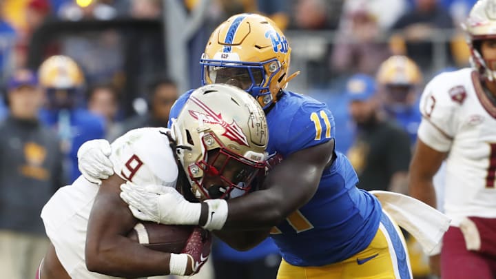 Nov 4, 2023; Pittsburgh, Pennsylvania, USA;  Pittsburgh Panthers linebacker Bangally Kamara (11) tackles Florida State Seminoles running back Lawrance Toafili (9) in the backfield during the second quarter at Acrisure Stadium. Mandatory Credit: Charles LeClaire-Imagn Images