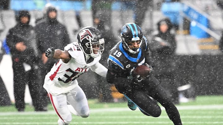 Dec 17, 2023; Charlotte, North Carolina, USA; Carolina Panthers wide receiver Adam Thielen (19) is tackled by Atlanta Falcons cornerback Clark Phillips III (34) in the third quarter at Bank of America Stadium. Mandatory Credit: Bob Donnan-Imagn Images