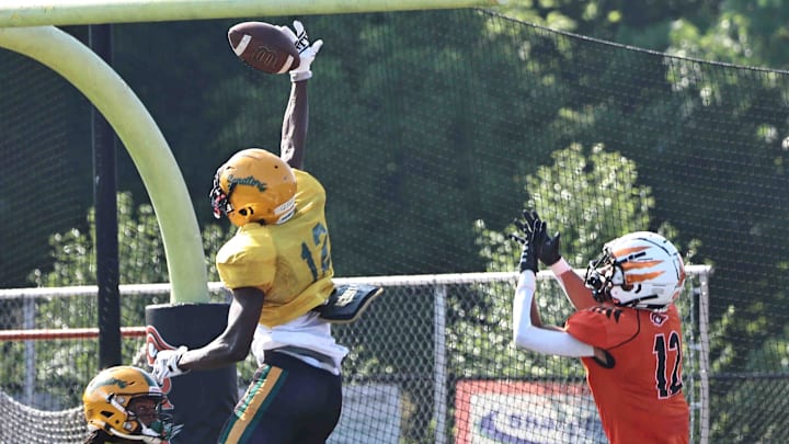 Taft defensive back Quinton Price (12), who has committed to UC, breaks up a pass intended for Trace Jallick (12) during their scrimmage Friday, Aug. 4, 2023. Taft defensive back Quinton Price (12), who has committed to UC, breaks up a pass intended for Trace Jallick (12) during their scrimmage Friday, Aug. 4, 2023.