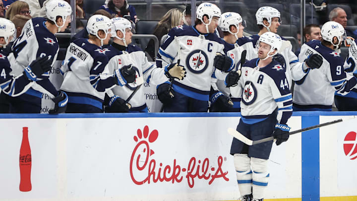 Mar 4, 2025; Elmont, New York, USA;  Winnipeg Jets defenseman Josh Morrissey (44) greets his teammates after scoring a goal in the second period against the New York Islanders at UBS Arena. Mandatory Credit: Wendell Cruz-Imagn Images