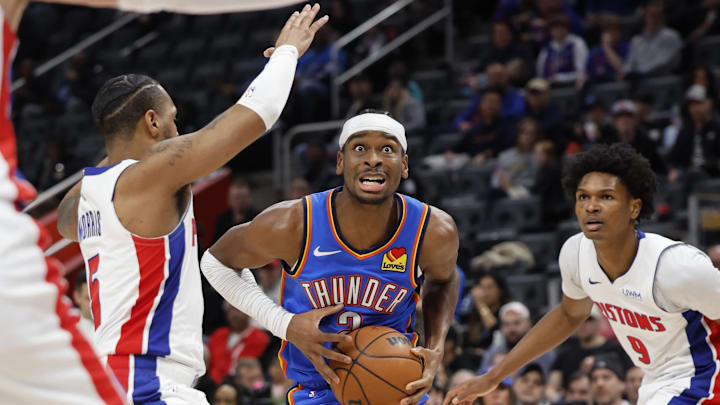 Jan 28, 2024; Detroit, Michigan, USA;  Oklahoma City Thunder guard Shai Gilgeous-Alexander (2) dribbles defended by Detroit Pistons guard Monte Morris (5) in the first half at Little Caesars Arena. Mandatory Credit: Rick Osentoski-Imagn Images