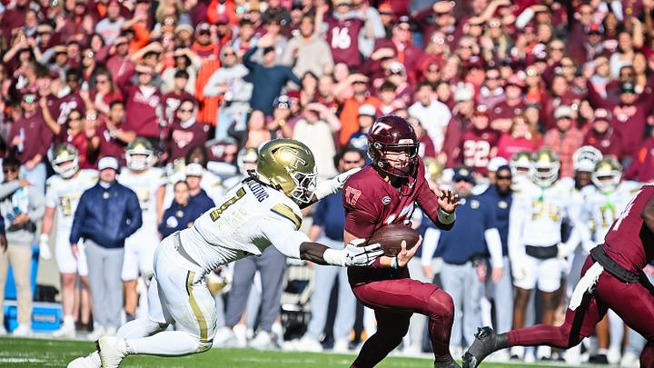 Oct 17, 2026; Blacksburg, Virginia, USA;  Virginia Tech Hokies quarterback Ethan Grunkemeyer (17) breaks a tackle from Georgia Tech Yellow Jackets linebacker Cayman Spaulding (1) on his way for a touchdown during the first quarter at Lane Stadium.  Mandatory Credit: Brian Bishop-Imagn Images