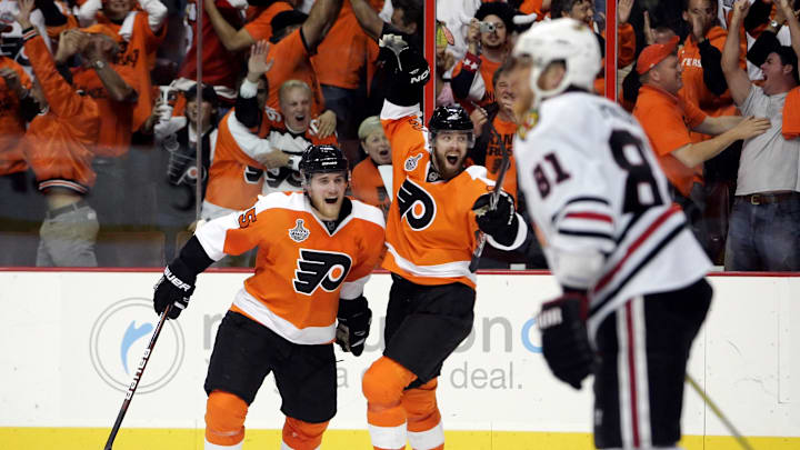 June 9, 2010; Philadelphia, PA, USA; Philadelphia Flyers left wing Ville Leino (center) and defenseman Matt Carle (left) celebrate a goal by left wing Scott Hartnell (not pictured) during the third period of game six of the 2010 Stanley Cup Finals as Chicago Blackhawks right wing Marian Hossa (81) skates away at the Wachovia Center. The Blackhawks won 4-3 to win the Stanley Cup.