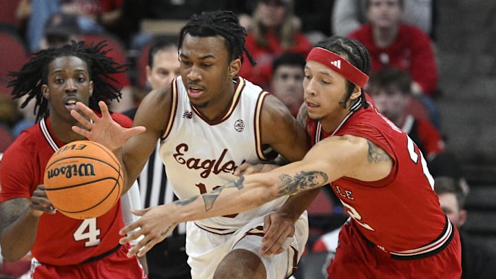 Mar 9, 2024; Louisville, Kentucky, USA; Boston College Eagles guard Donald Hand Jr. (13) dribbles under the pressure of Louisville Cardinals guard Tre White (22) during the first half at KFC Yum! Center. Mandatory Credit: Jamie Rhodes-Imagn Images Mar 9, 2024; Louisville, Kentucky, USA; Boston College Eagles guard Donald Hand Jr. (13) dribbles under the pressure of Louisville Cardinals guard Tre White (22) during the first half at KFC Yum! Center. Mandatory Credit: Jamie Rhodes-Imagn Images