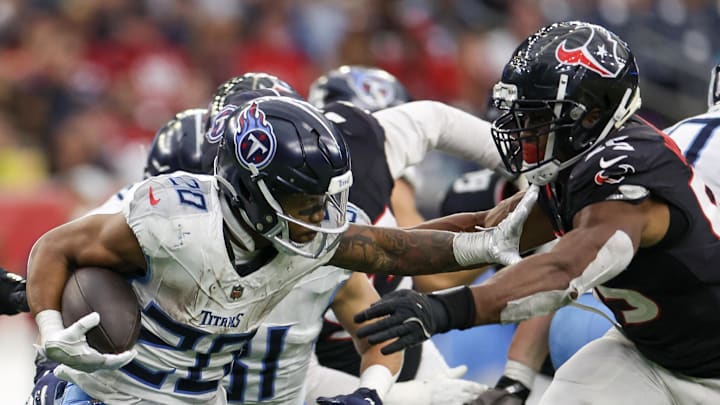 Nov 24, 2024; Houston, Texas, USA; Tennessee Titans running back Tony Pollard (20) stiff arms Houston Texans defensive end Danielle Hunter (55) in the fourth quarter at NRG Stadium. Mandatory Credit: Thomas Shea-Imagn Images Nov 24, 2024; Houston, Texas, USA; Tennessee Titans running back Tony Pollard (20) stiff arms Houston Texans defensive end Danielle Hunter (55) in the fourth quarter at NRG Stadium. Mandatory Credit: Thomas Shea-Imagn Images
