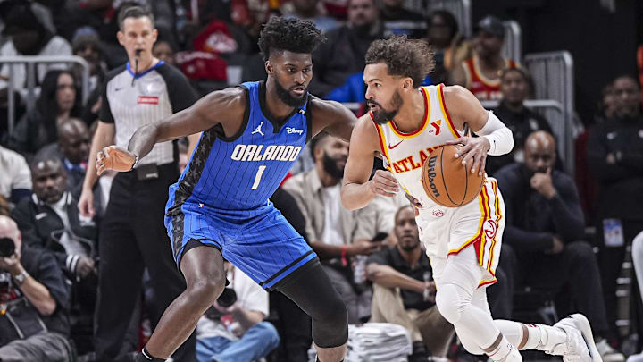 Feb 20, 2025; Atlanta, Georgia, USA; Atlanta Hawks guard Trae Young (11) dribbles against Orlando Magic forward Jonathan Isaac (1) during the first half at State Farm Arena. Mandatory Credit: Dale Zanine-Imagn Images