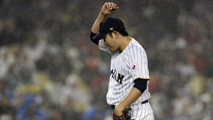 March 21, 2017; Los Angeles, CA, USA; Japan pitcher Tomoyuki Sugano (11) reacts after drawing a walk to USA infielder Eric Hosmer (35) in the fourth inning during the 2017 World Baseball Classic at Dodger Stadium.