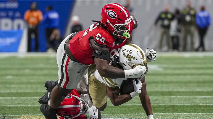 Nov 28, 2025; Atlanta, Georgia, USA; Georgia Tech Yellow Jackets running back Chad Alexander (27) is tackled by Georgia Bulldogs defensive lineman Christen Miller (52) and safety Zion Branch (2) during the second half at Mercedes-Benz Stadium. Mandatory Credit: Dale Zanine-Imagn Images Nov 28, 2025; Atlanta, Georgia, USA; Georgia Tech Yellow Jackets running back Chad Alexander (27) is tackled by Georgia Bulldogs defensive lineman Christen Miller (52) and safety Zion Branch (2) during the second half at Mercedes-Benz Stadium. Mandatory Credit: Dale Zanine-Imagn Images