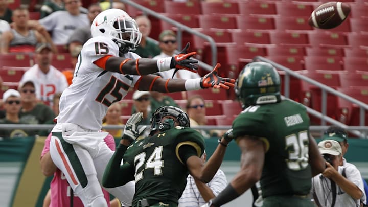 Sep 28, 2013; Tampa, FL, USA; South Florida Bulls defensive back Johnny Ward (24) defends Miami Hurricanes wide receiver D'Mauri Jones (15) during the second half at Raymond James Stadium. Miami Hurricanes defeated the South Florida Bulls 49-21. Mandatory Credit: Kim Klement-Imagn Images