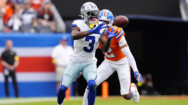 Dallas Cowboys wide receiver George Pickens makes a catch against Denver Broncos cornerback Pat Surtain II in the second quarter  at Empower Field at Mile High.