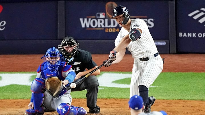 New York Yankees designated hitter Giancarlo Stanton (27) hits a double during the fourth inning against the Los Angeles Dodgers in game three of the 2024 MLB World Series at Yankee Stadium. 