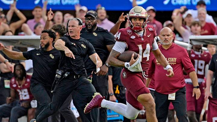 Oct 3, 2026; Tallahassee, Florida, USA; Florida State Seminoles quarterback Ashton Daniels (14) runs for a touchdown as head coach Mike Norvell cheers on the sidelines during the second half against the Virginia Cavaliers at Doak S. Campbell Stadium. Mandatory Credit: Melina Myers-Imagn Images Oct 3, 2026; Tallahassee, Florida, USA; Florida State Seminoles quarterback Ashton Daniels (14) runs for a touchdown as head coach Mike Norvell cheers on the sidelines during the second half against the Virginia Cavaliers at Doak S. Campbell Stadium. Mandatory Credit: Melina Myers-Imagn Images