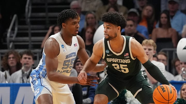 March 23, 2024, Charlotte, NC, USA; Michigan State Spartans forward Malik Hall (25) dribbles against North Carolina Tar Heels forward Harrison Ingram (55)  in the second round of the 2024 NCAA Tournament at the Spectrum Center. Mandatory Credit: Jim Dedmon-USA TODAY Sports