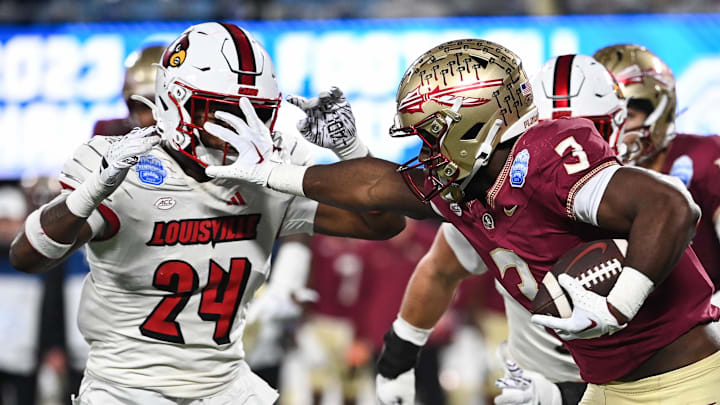 Dec 2, 2023; Charlotte, NC, USA; Florida State Seminoles running back Trey Benson (3) fends off