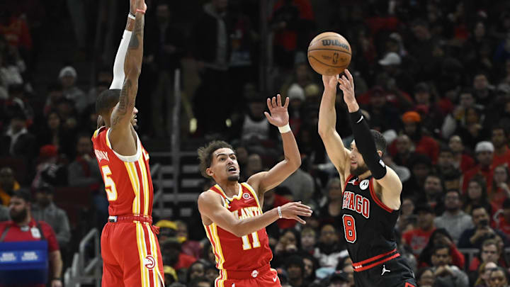 Jan 23, 2023; Chicago, Illinois, USA; Chicago Bulls guard Zach LaVine (8) passes the ball against Atlanta Hawks guards Dejounte Murray (5) and Trae Young (11) during the second half at the  United Center. Mandatory Credit: Matt Marton-USA TODAY Sports
