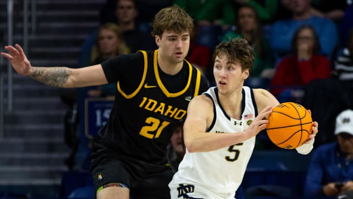 Dec 10, 2025; South Bend, Indiana, USA; Notre Dame Fighting Irish guard Cole Certa (5) looks to pass as Idaho Vandals forward Seth Joba (21) defends during the second half at Purcell Pavilion at the Joyce Center. Mandatory Credit: Michael Caterina-Imagn Images