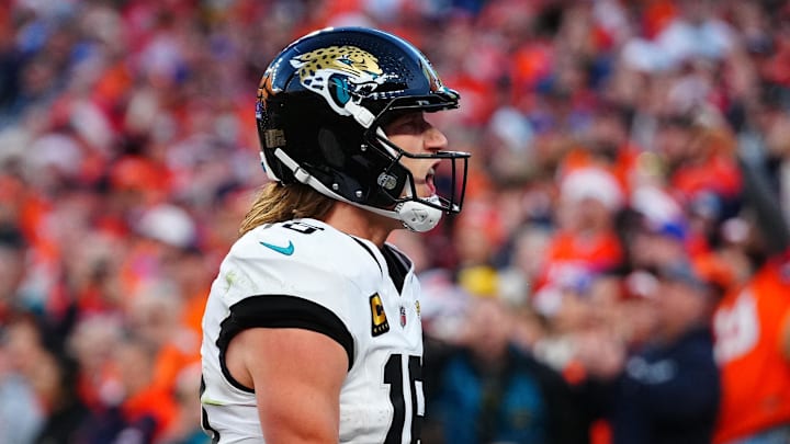 Dec 21, 2025; Denver, Colorado, USA; Jacksonville Jaguars quarterback Trevor Lawrence (16) reacts after rushing for a touchdown against the Denver Broncos during the second half at Empower Field at Mile High. Mandatory Credit: Ron Chenoy-Imagn Images