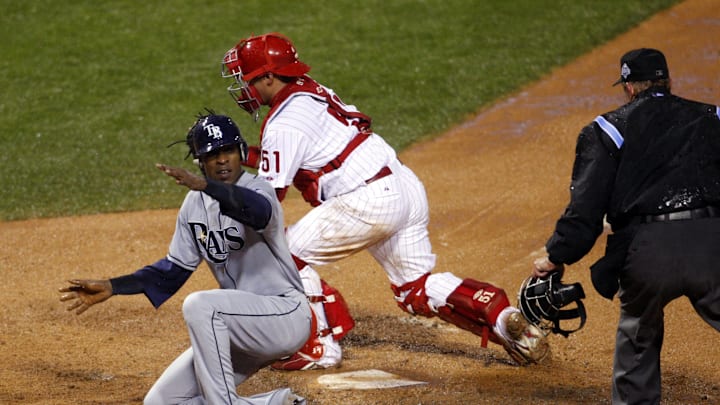 Oct 27, 2008; Philadelphia, PA, USA; Tampa Bay Rays center fielder B.J. Upton (left) slides wafely past Philadelphia Phillies catcher Carlos Ruiz (51) with the game tying run during the sixth inning of game five of the World Series at Citizens Bank Park. Mandatory Credit: Howard Smith-Imagn Images