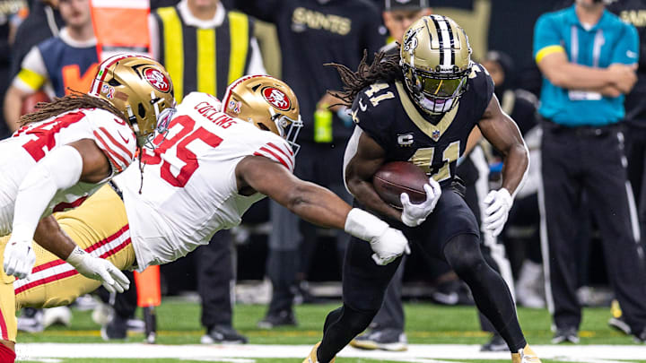 Sep 14, 2025; New Orleans, Louisiana, USA;  New Orleans Saints running back Alvin Kamara (41) runs against San Francisco 49ers defensive tackle Alfred Collins (95) during the first half at Caesars Superdome. Mandatory Credit: Stephen Lew-Imagn Images