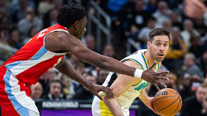 Feb 20, 2025; Indianapolis, Indiana, USA; Indiana Pacers guard T.J. McConnell (9) dribbles the ball while Memphis Grizzlies guard Vince Williams Jr. (5) defends in the second half at Gainbridge Fieldhouse. Mandatory Credit: Trevor Ruszkowski-Imagn Images