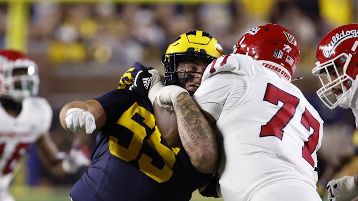 Aug 31, 2024; Ann Arbor, Michigan, USA;  Fresno State Bulldogs offensive lineman Toreon Penright (77) blocks Michigan Wolverines defensive lineman Mason Graham (55) in the second half at Michigan Stadium. Mandatory Credit: Rick Osentoski-Imagn Images