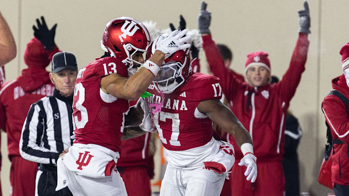 Nov 30, 2024; Bloomington, Indiana, USA; Indiana Hoosiers running back Ty Son Lawton (17) scores a touchdown and celebrates with teammates  in the first half against the Purdue Boilermakers at Memorial Stadium. Mandatory Credit: Trevor Ruszkowski-Imagn Images